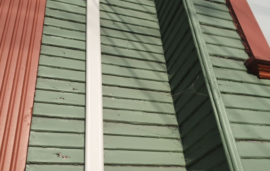 Closeup of worn exterior paint in Oakland